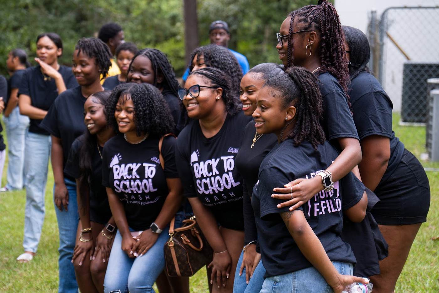 EFF students in Back to School Bash shirts laughing together outdoors